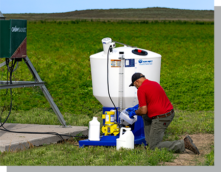 a man filling a chemigation tank in field